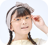 トマトグラッシーズを着用してポーズをとり、笑顔を見せる女の子。